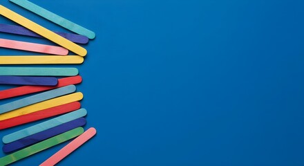 Fototapeta premium Colorful, Craft sticks, Popsicle sticks, Colorful Craft Sticks on Blue Background