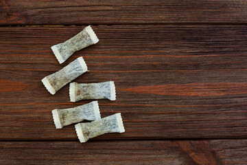 Nicotine snus pads arranged neatly on a wooden surface for brewing hot beverages