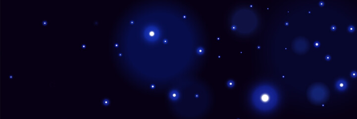 Blue glowing particles on dark background with soft bokeh light effect and dreamy cosmic atmosphere