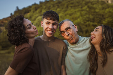 Portrait of caucasian family have fun and gesturing together in nature