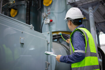 Gas insulated switchgear substation engineer inspects electrical equipment wearing safety helmet...
