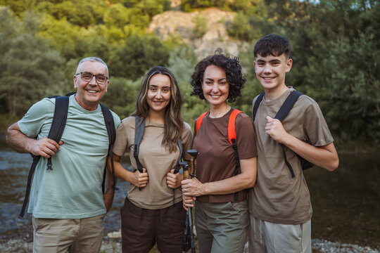 happy family of backpackers hikers explore nature together