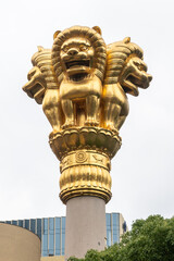 Ornate, gleaming gold sculpture featuring lions mounted atop a column at Jing'an Temple,...