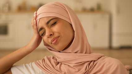 Portrait sad thinking frustrated sick ill bad feeling stress Indian woman Arabian girl Muslim...