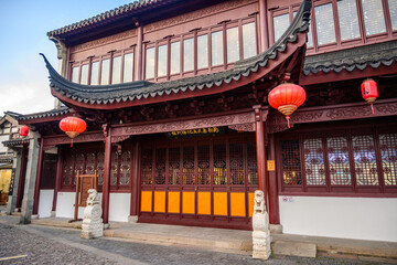 Elaborate architecture with ornate red lanterns, detailed woodwork and tiles at Nanxiang Water Town...