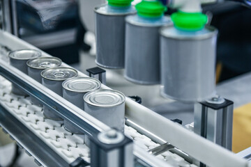 Canned food products on conveyor belt in distribution warehouse.food transportation system concept