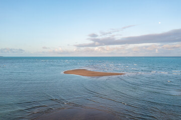 A small island formed in the Japaratinga beach during high tide. Alagoas, Brazil.