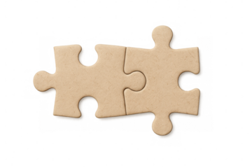 Cardboard puzzle pieces interlocking, representing collaborative problem-solving and partnership against transparent backdrop