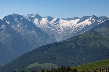 Magnificent mountain range in Austria showcasing snowy peaks and clear blue skies during a sunny day