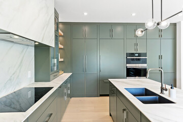 Kitchen with a marble countertop and a white sink