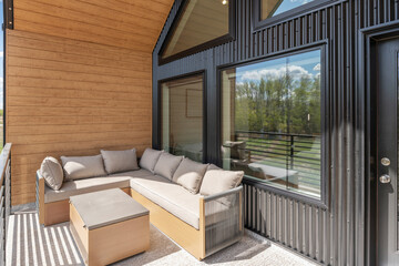 Black and tan patio with a couch and a table