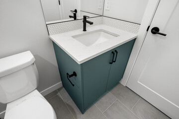 Bathroom with a white sink and a black toilet