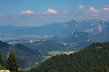 Obraz premium Scenic mountain view of the Füssen region in Germany showcasing valleys and peaks under a clear sky