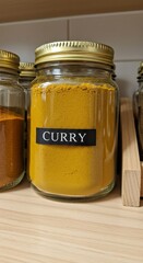 Golden Curry Powder in Glass Jar on Wooden Shelf