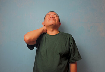 Man Holding Neck in Pain Expression
