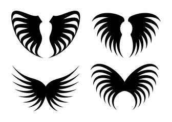 Fototapeta premium Collection of four stylized black wing silhouettes with a feathered appearance on a white background
