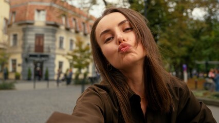 Mobile phone camera view happy smiling Caucasian woman posing smiling make selfie at street female girl in city holding smartphone video call record vlog photo picture online live broadcasting stream