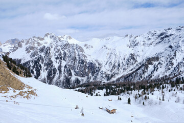 Fototapeta premium March 2025: Scenic view of snow covered mountains against sky, Fassa Valley.