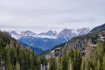 Obraz premium March 2025: winter landscape at Ski Area in Dolomites, Italy - Alpe Lusia. Ski resort in val di Fassa near Moena. Winter Dolomites and blue sky. Aerial view on ski slopes
