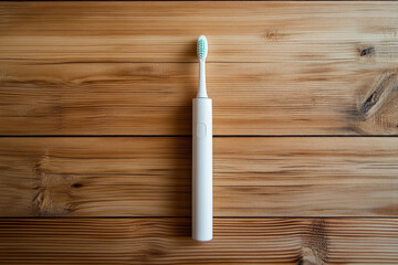 White electric toothbrush is lying on wooden planks, promoting oral hygiene and dental health