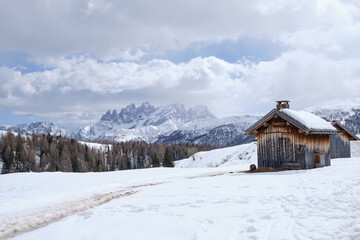 Fototapeta premium March 2025: winter landscape at Ski Area in Dolomites, Italy - Alpe Lusia. Ski resort in val di Fassa near Moena. Winter Dolomites and blue sky. Aerial view on ski slopes