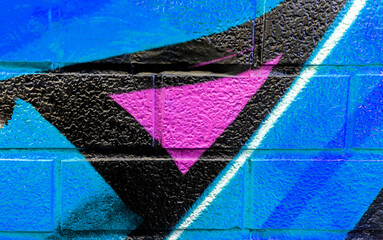 Art under ground. Beautiful street art graffiti background. The brick wall is decorated with abstract drawings house paint. Modern style urban culture of street youth. Abstract picture on wall