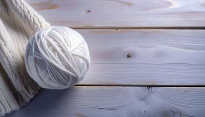 Knitting wool yarn balls in on a wooden table with copy space. Cozy knitting scene with warm texture, ideal for craft, handmade, or winter-themed designs.
