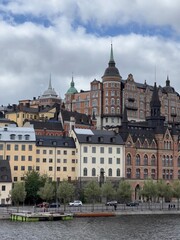 Obraz premium Colorful Historic Buildings and Towers by the Water in Stockholm, Sweden