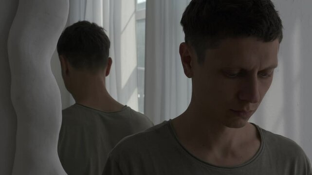 Person avoids mirror reflection, symbolizing self-denial and mental struggle. Concept of inner struggle and emotional detachment.