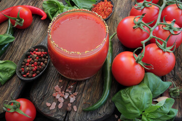 The concept, fresh tomatoes, natural spices, herbs and olive oil are the pearls of Italian cuisine. On an old vintage wooden table, fresh tomatoes of different varieties, spices, herbs, olive oil 
