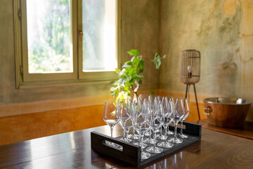 An aesthetic arrangement of elegant wine glasses complemented by natural light in a cozy and...