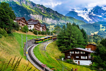 Beautiful mountain landscape with train in canyon of the city Lauterbrunnen in the Swiss Alps, Switzerland. Amazing places.