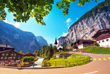 The picturesque landscape with waterfall and canyon church in Lauterbrunnen in the Swiss Alps, Switzerland, Europe