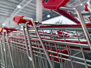 A row of shopping carts is neatly lined up in a straight row