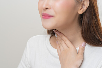Sickness in inflaming asian young woman, girl use hand check self touch at sore throat, pain...