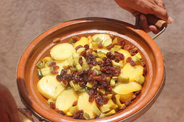 Hands Holding a Fresh Moroccan Tajine