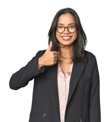 Young Latina professional in studio smiling and raising thumb up