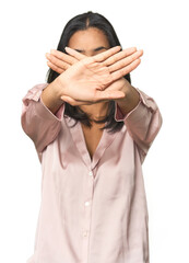 Simple portrait of a young Latina doing a denial gesture