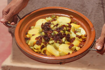 Hands Holding a Fresh Moroccan Tajine