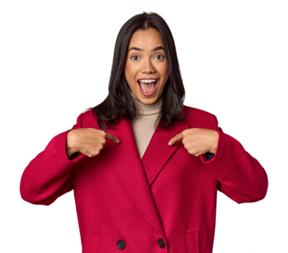 Young filipino woman surprised pointing with finger, smiling broadly.