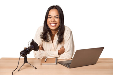 Filipino woman podcasting with mic and laptop