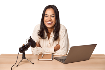 Filipino woman podcasting with mic and laptop
