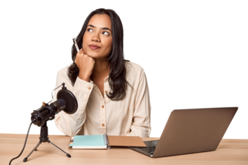 Filipino woman podcasting with mic and laptop