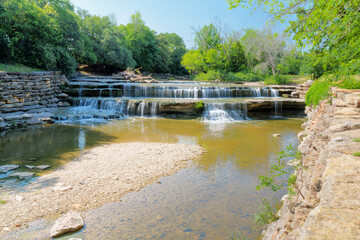 A large fallen tree is snagged at Airfield Falls along the Trinity Trails in west Fort Worth, Texas...