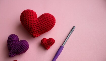 crocheted amigurumi purple red burgundy hearts with crochet hook on a pink background valentine s day banner