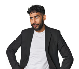 Hispanic businessman in suit in studio confused, feels doubtful and unsure.