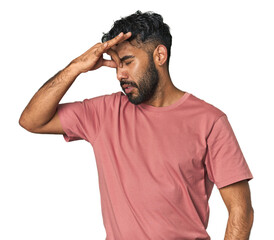 Young Hispanic man isolated having a head ache, touching front of the face.