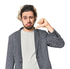 Young businessman in casual blazer showing thumb down, disappointment concept.