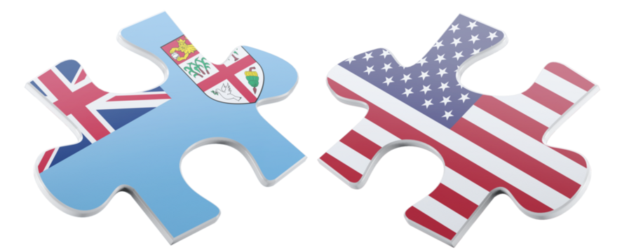 Two puzzle pieces, one displaying the flag of Fiji and the other adorned with the flag of the United States, symbolize potential collaboration and the intricate connections.