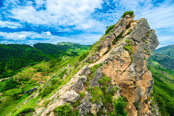 Beautiful view of rocky peak above green mountains. Dagestan, Caucasus